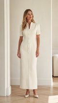 Front full view of woman wearing ivory short sleeve stand collar column maxi dress with covered buttons
