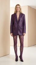 Front full-length view of model wearing a deep purple faux leather longline blazer