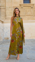 Front view of model wearing olive green one-shoulder floral print maxi dress with draped cape sleeve