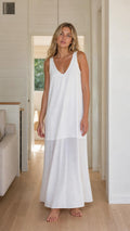 Front view of woman wearing white sleeveless maxi dress