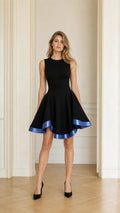 Front view of black fit and flare mini dress with blue contrast hem