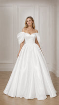 Front view of woman wearing white off-the-shoulder puff sleeve satin ball gown