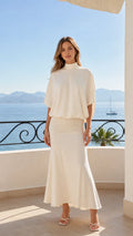 Front view of cream mock neck batwing top and maxi skirt set