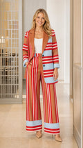 Front view of woman wearing brown striped blazer and wide-leg pants set