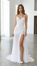 Front view of woman wearing white lace corset evening gown with high leg slit