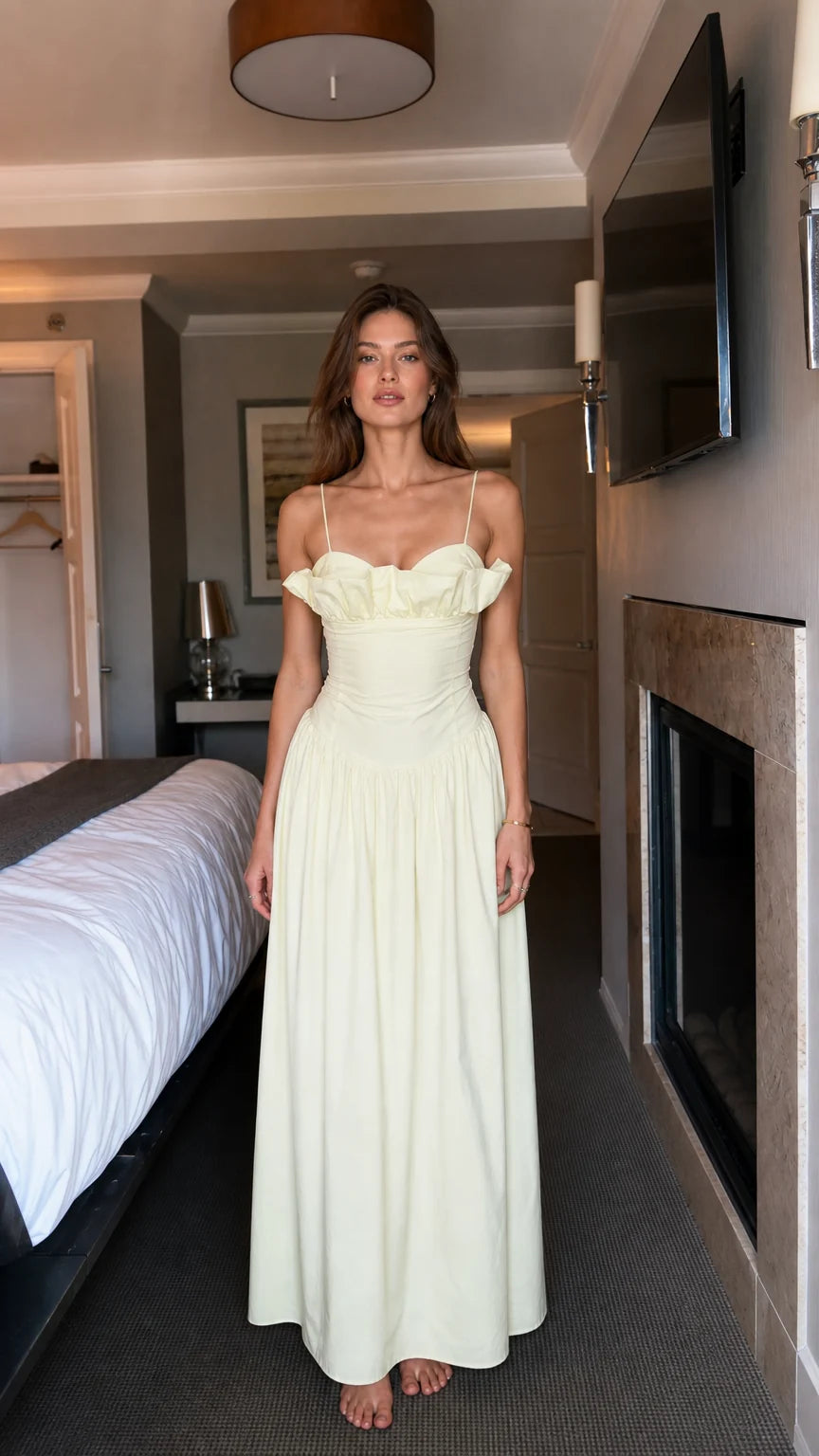 Front view of woman wearing light yellow ruffled maxi dress