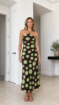 Model wearing brown polka dot halter midi dress, front view