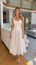 Front view of woman wearing white lace corset midi dress