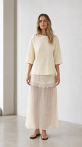Front view of woman wearing cream relaxed tee and matching mesh maxi skirt