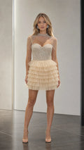 Front view of model wearing champagne beaded sequin ruffle mini dress