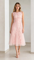 Front view of model wearing pink embroidered leaf applique midi dress