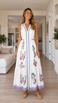 Front view of woman wearing white butterfly print maxi dress
