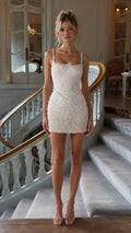 Full-length front view of white beaded mini dress