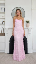 Front view of model wearing pink strapless floral applique maxi dress