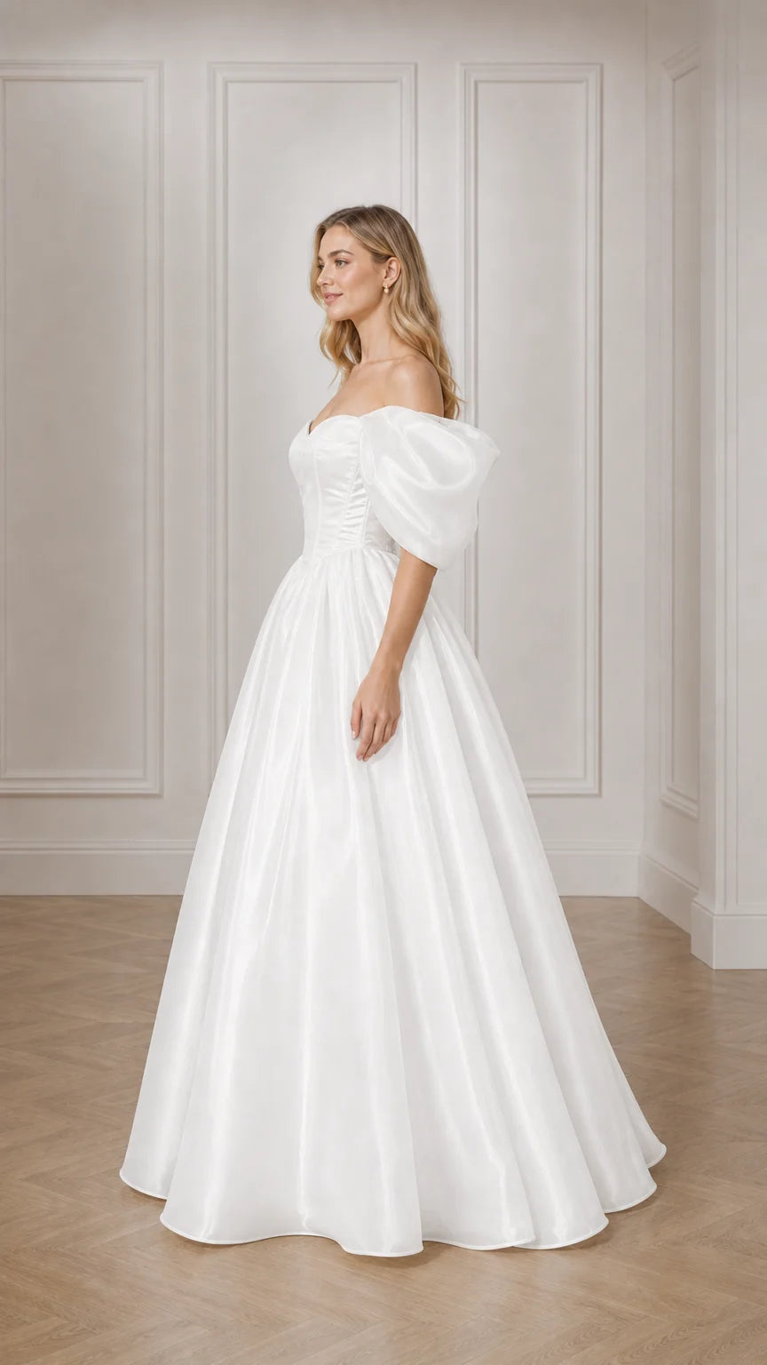 Side profile of woman in white satin ball gown