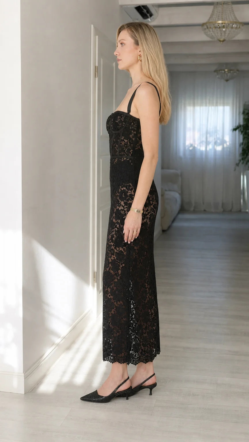 Side view of woman wearing black lace corset midi dress