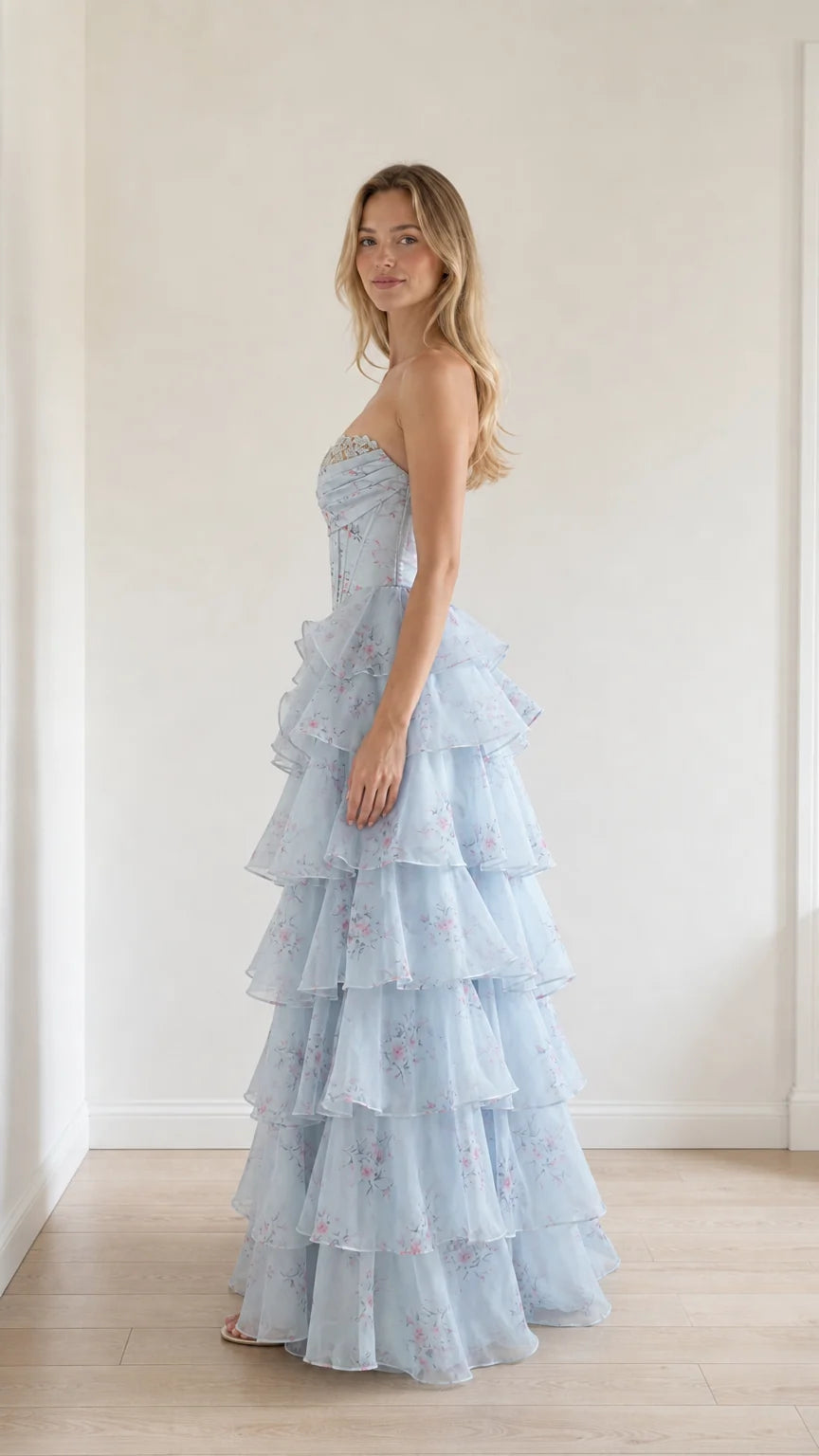Side profile view of light blue floral tiered ruffle gown