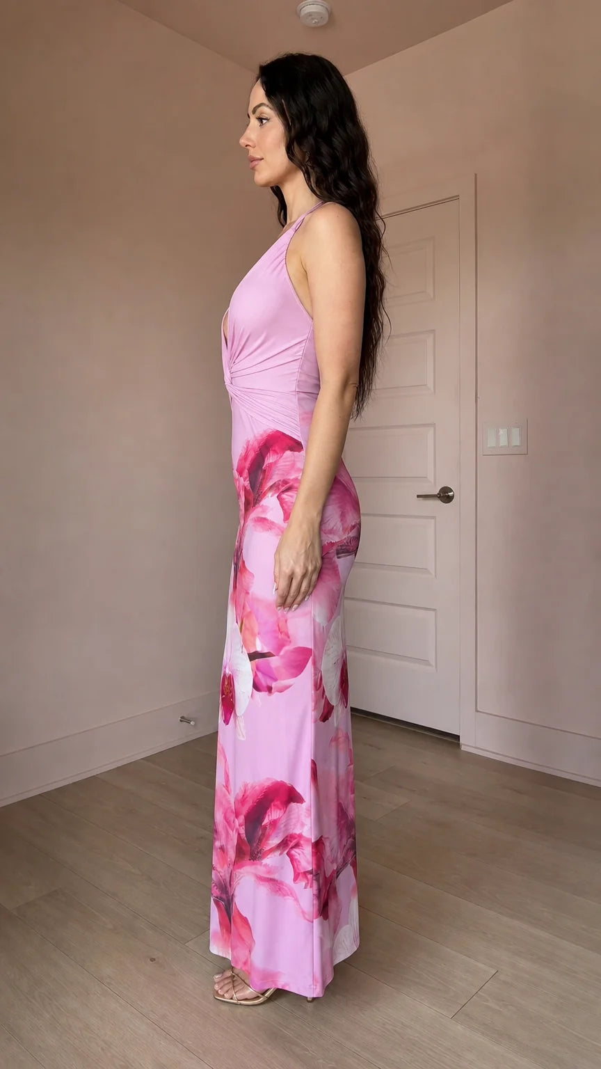 Model wearing pink floral print halter maxi dress, side profile