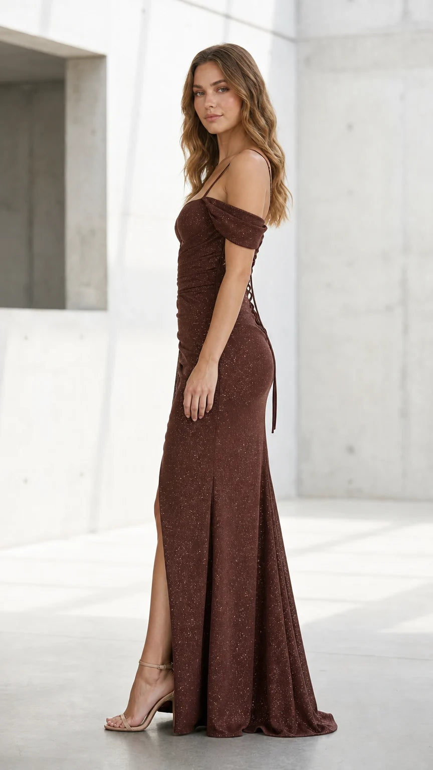 Side profile view of brown evening dress showing silhouette and floor-length hem
