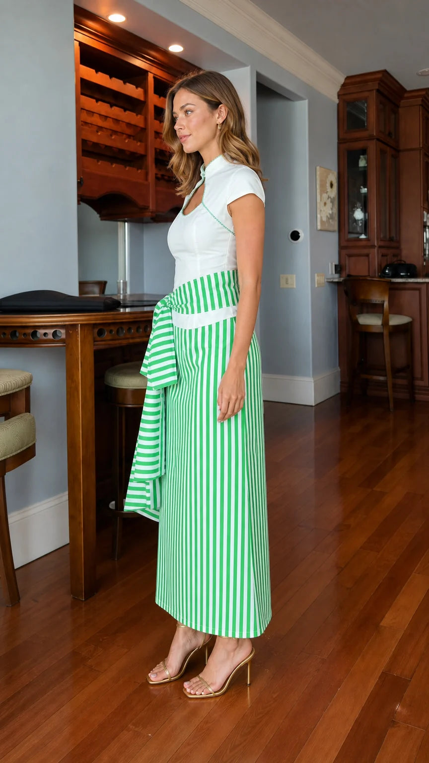 Model wearing white and green striped dress, side profile view