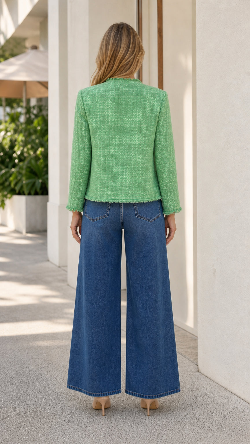 Back view of model in green tweed jacket