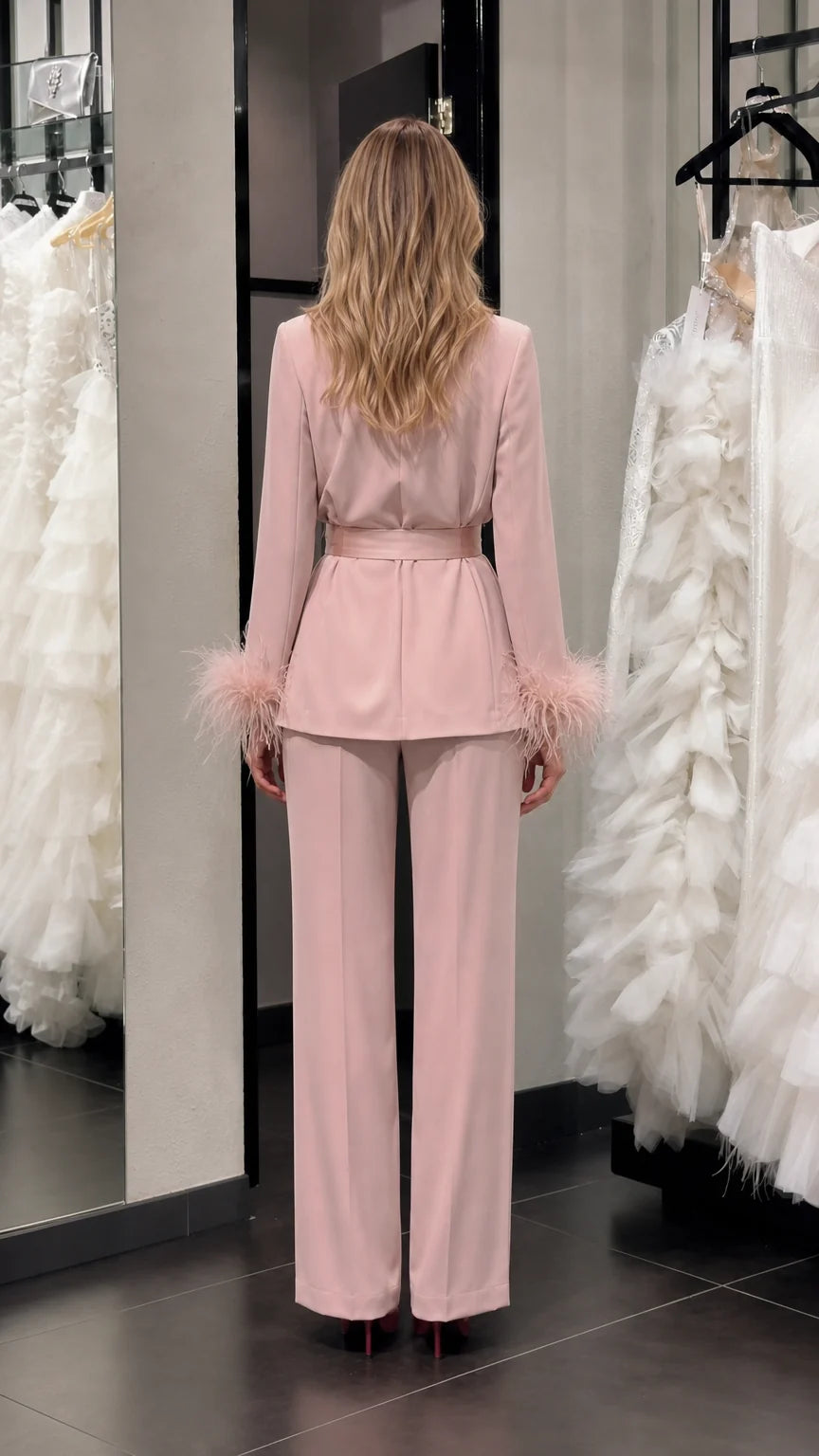 Model wearing pink satin feather cuff pantsuit back view