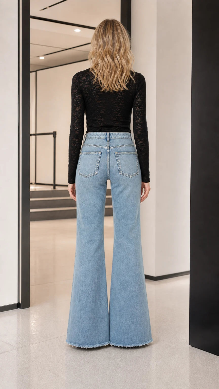 Model wearing black long-sleeve sheer lace top, back view