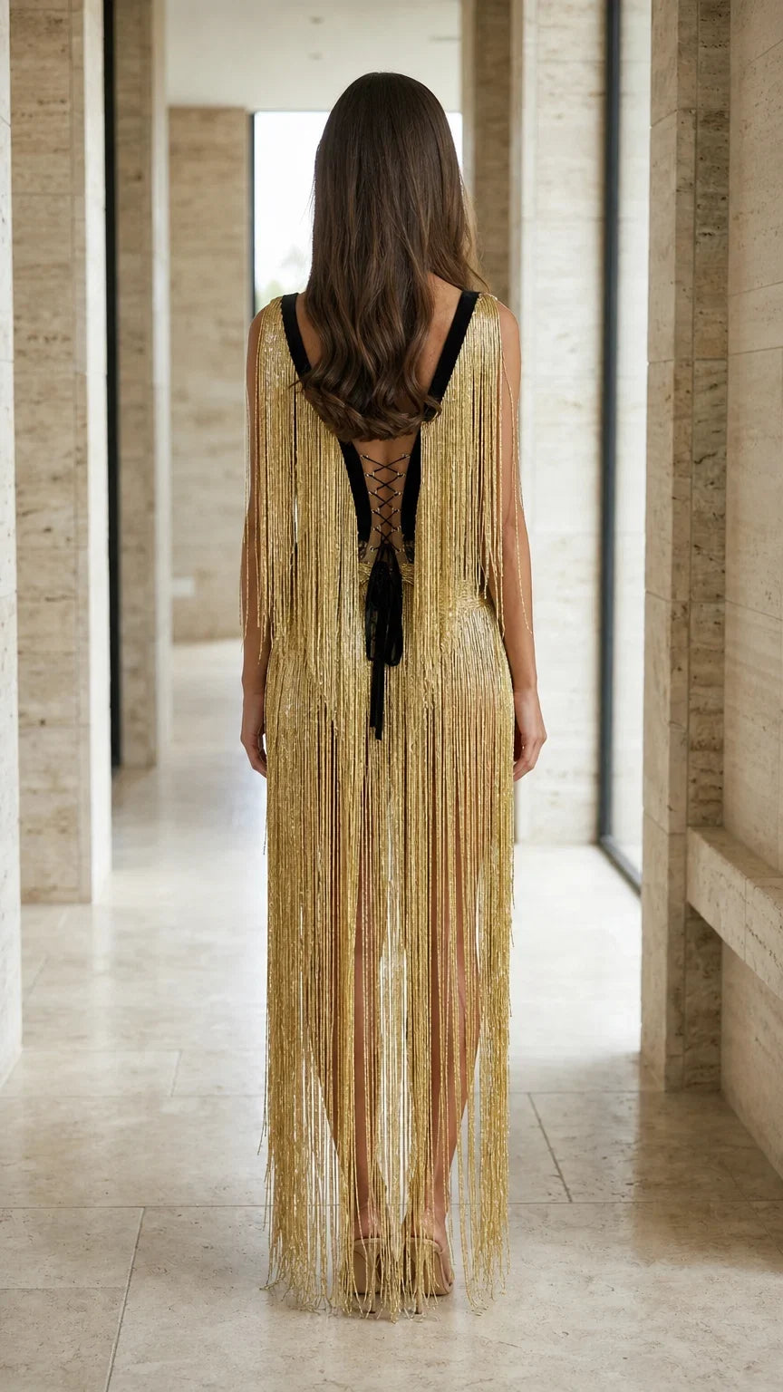 Back view of gold fringe dress featuring lace-up closure