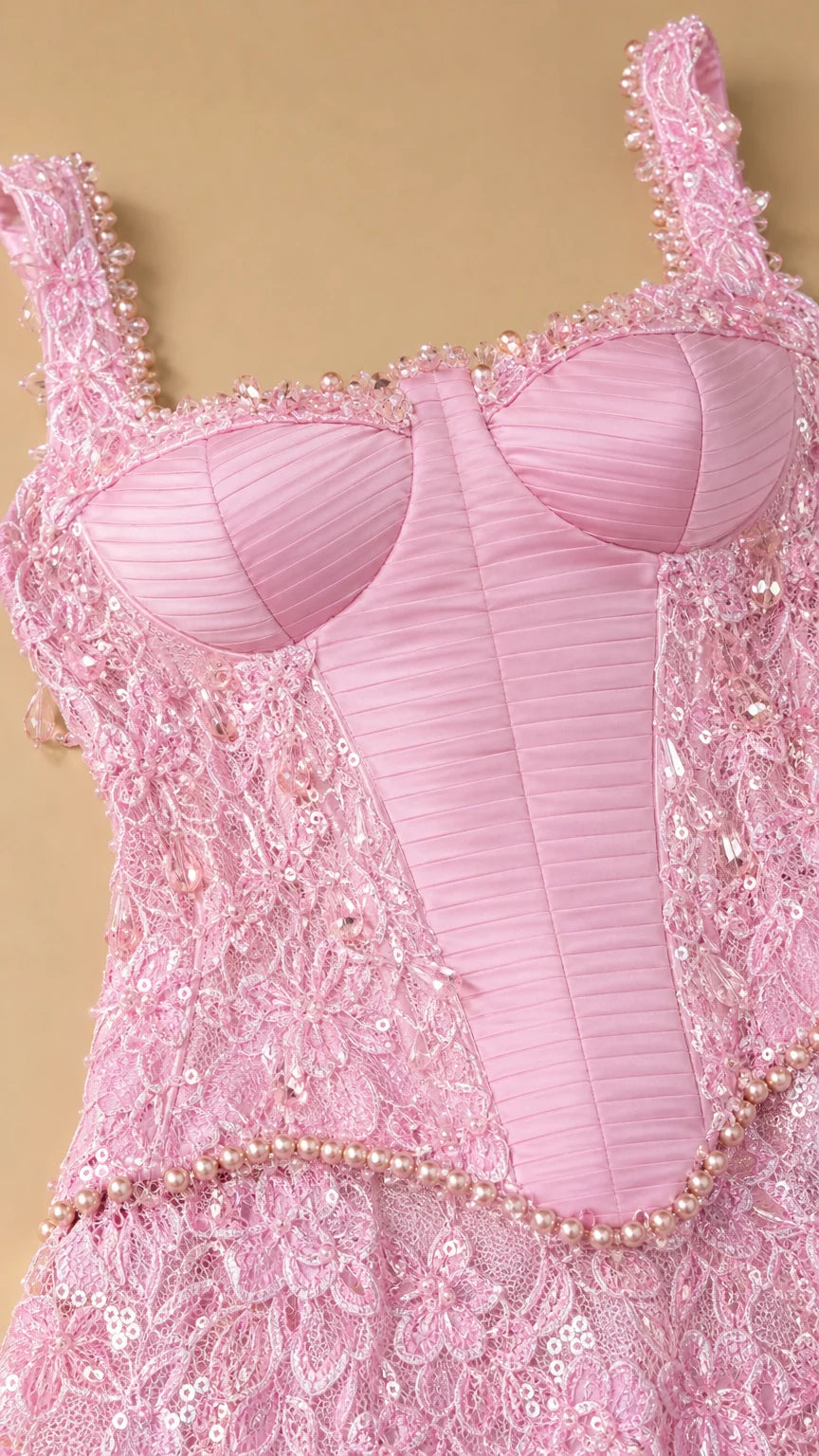 Close-up detail of structured pink corset bodice and beaded waist
