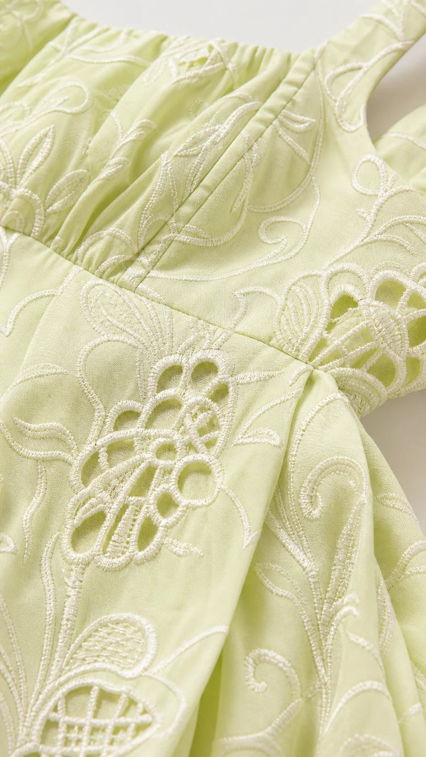 Close-up detail of tonal floral embroidery and eyelet cutwork on Light Green fabric