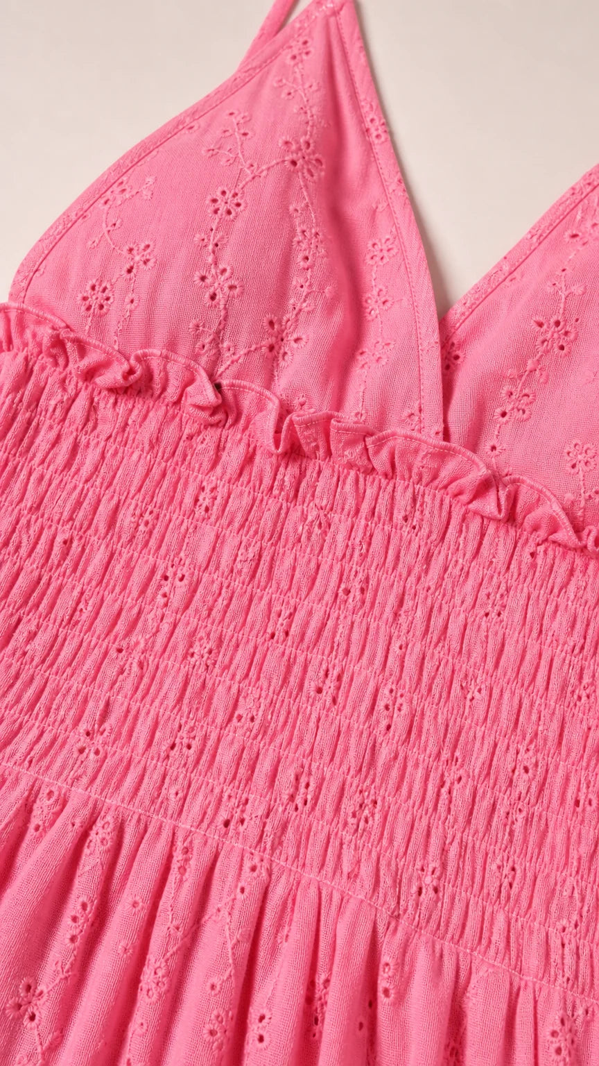 Close-up of pink dress textured fabric and smocked bodice detail