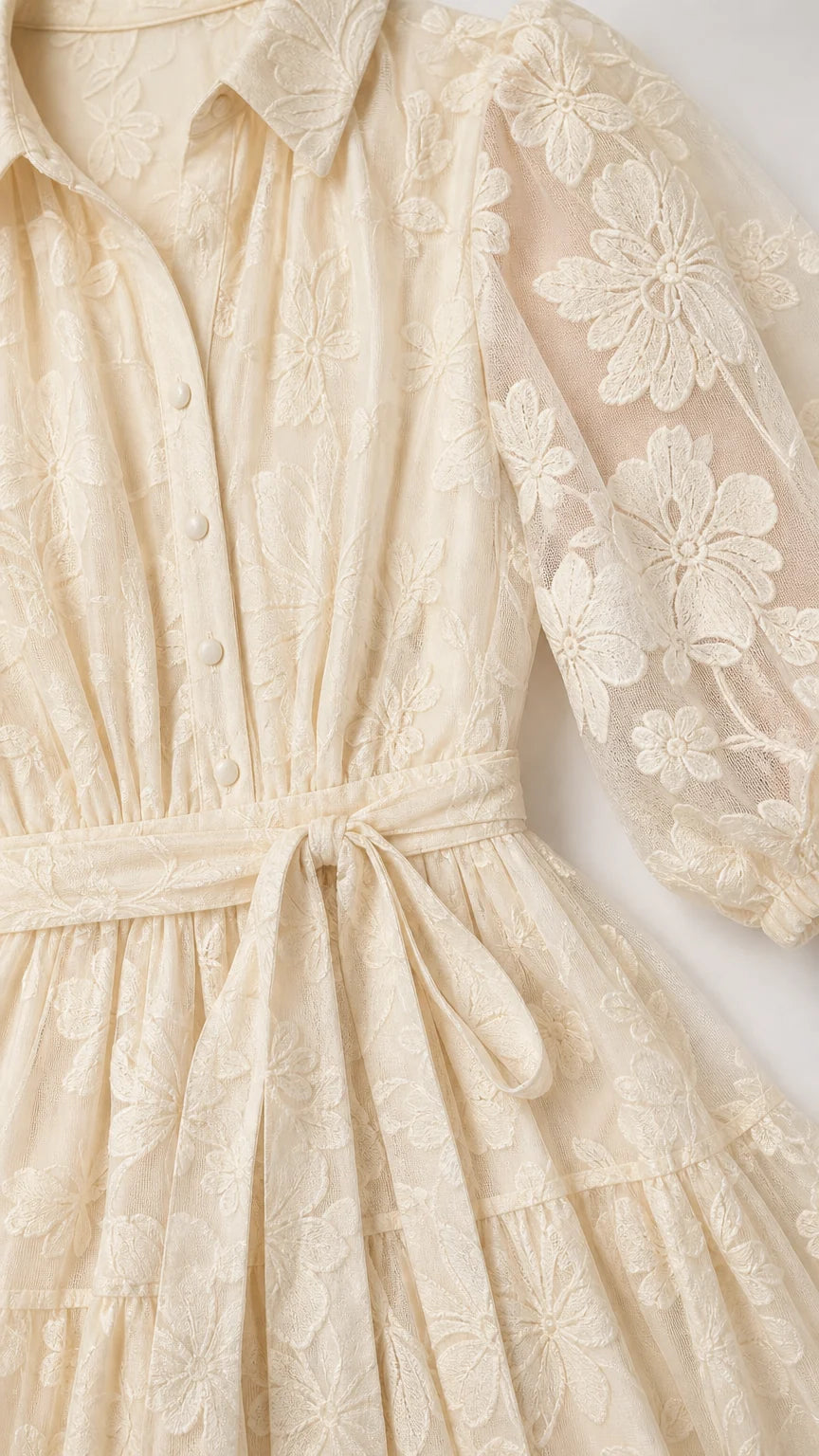 Close-up detail of shirt collar, buttons, and sheer floral embroidery