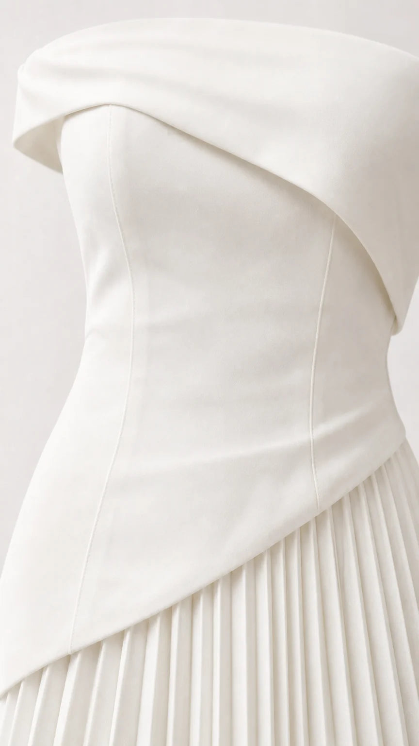 Close-up detail of white structured asymmetric bodice