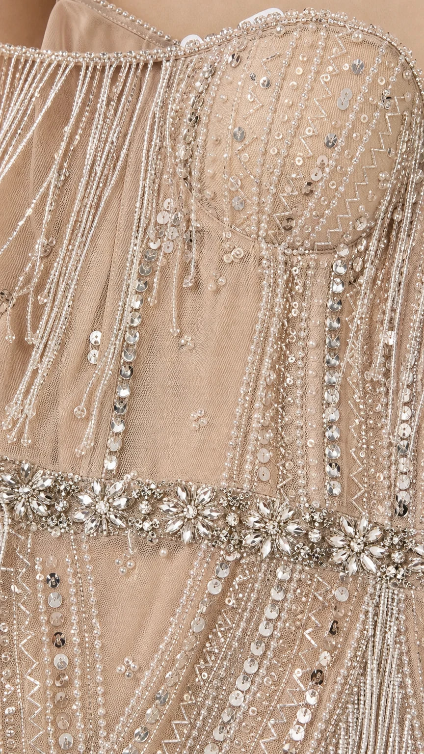 Close-up detail of bodice beadwork, sequins, and crystal waist belt