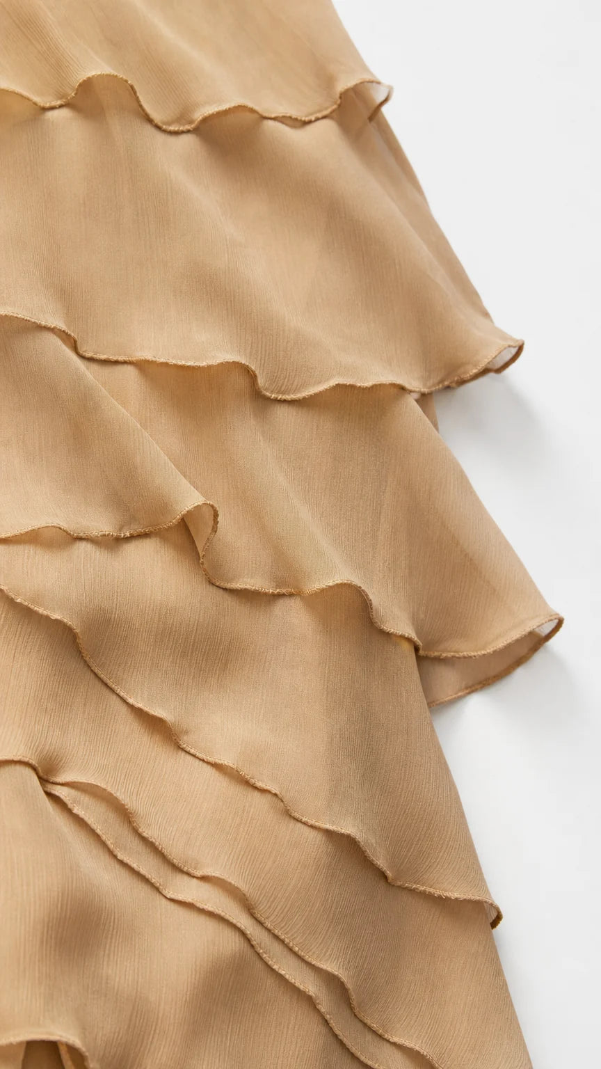 Close-up detail of beige chiffon layered ruffles