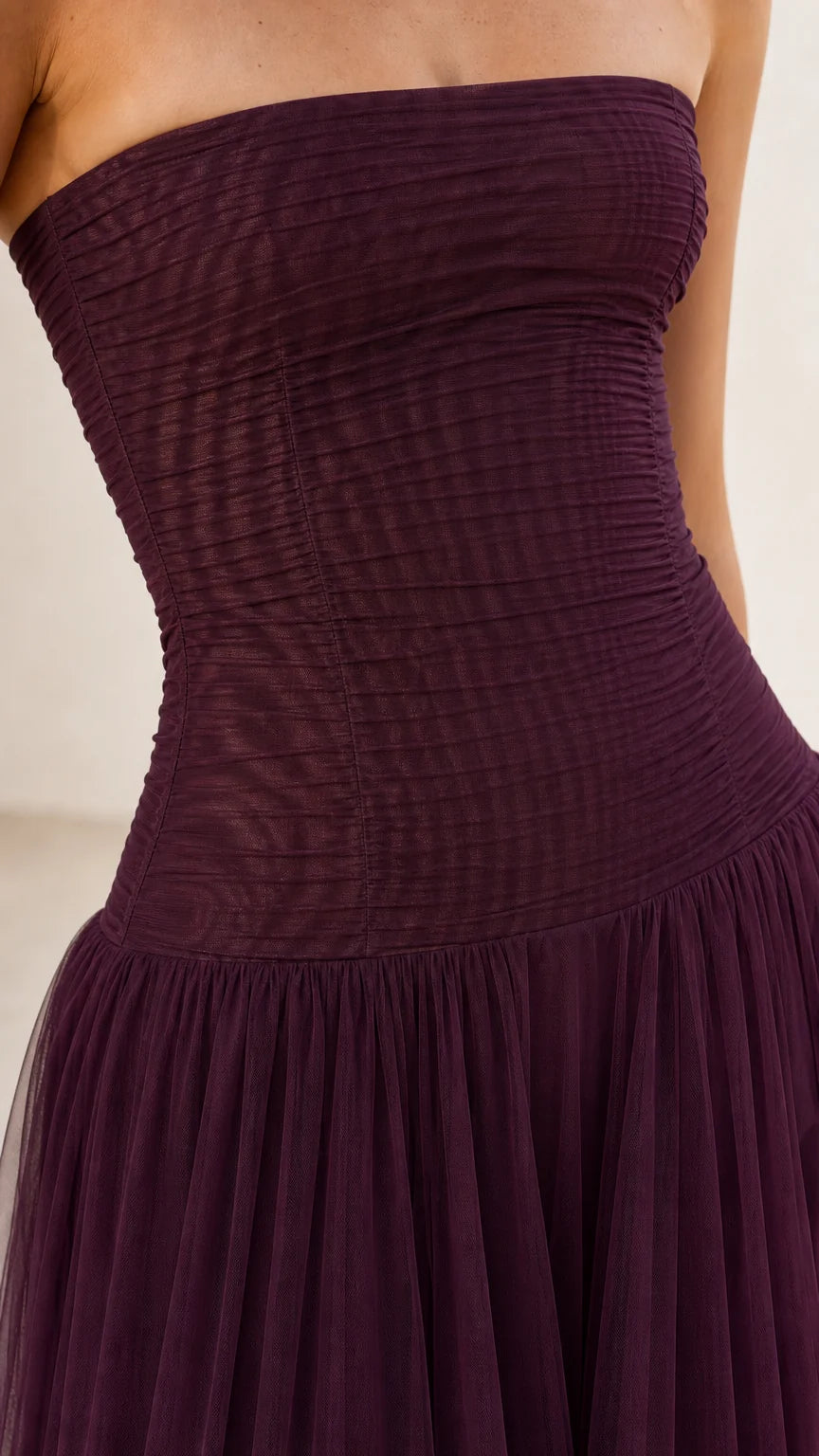 Close-up detail of ruched bodice on burgundy tulle dress