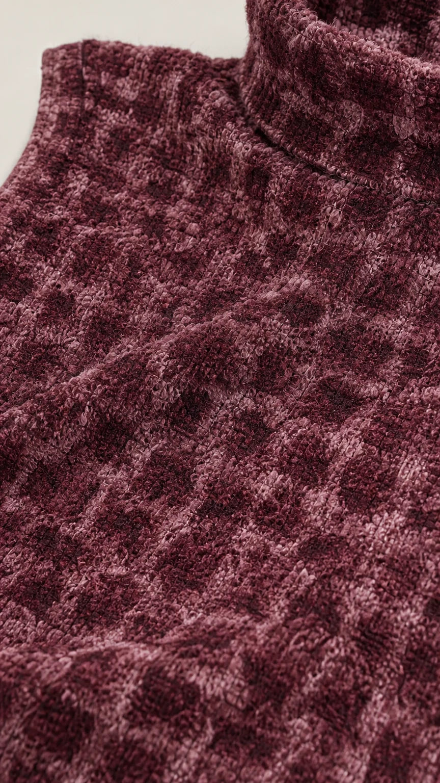 Close-up of fabric texture and mock neck detail in burgundy