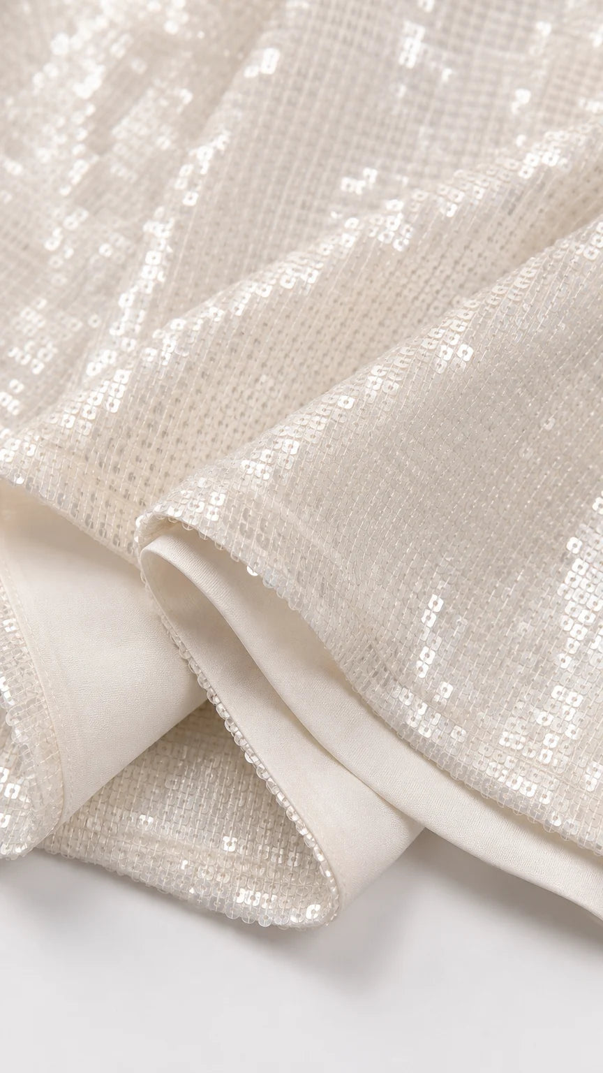 Close-up detail of white sequin fabric texture
