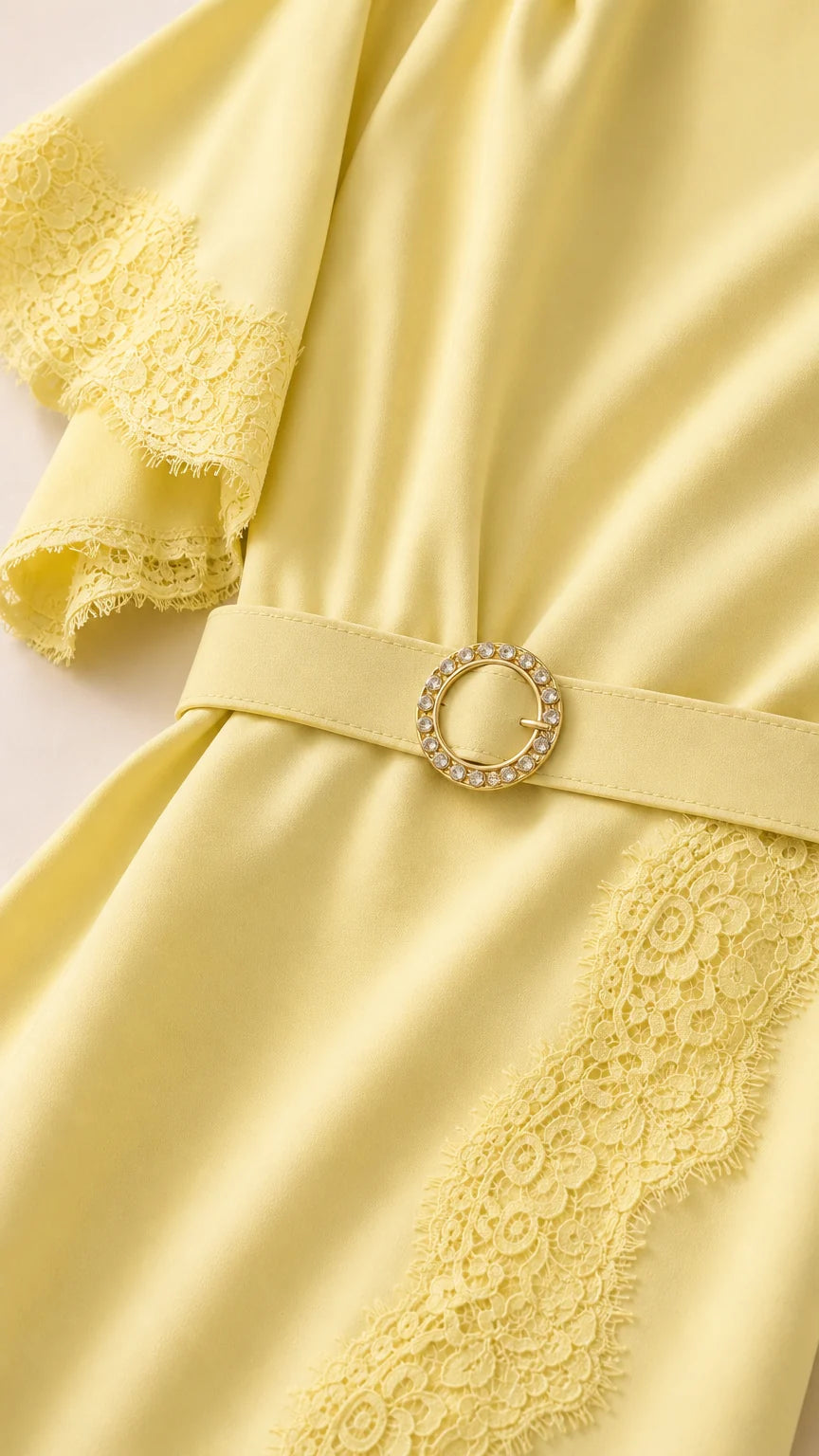 Close-up of flutter sleeve and belt detail on yellow dress