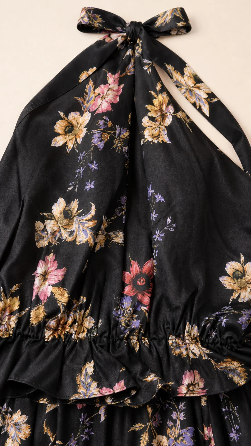 Close-up detail of black floral print fabric and back tie closure