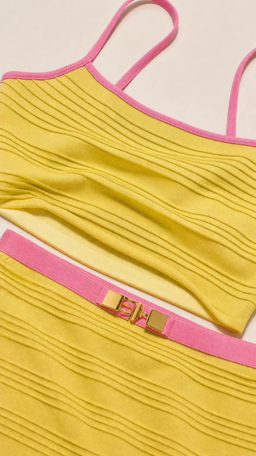 Close-up detail of yellow ribbed fabric and contrast pink trim