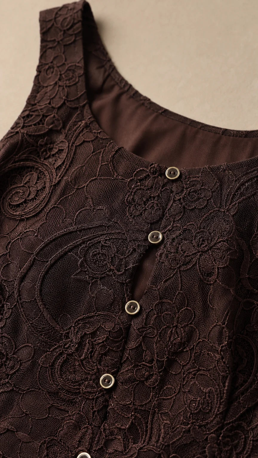 Close-up detail of dark brown lace fabric and front buttons