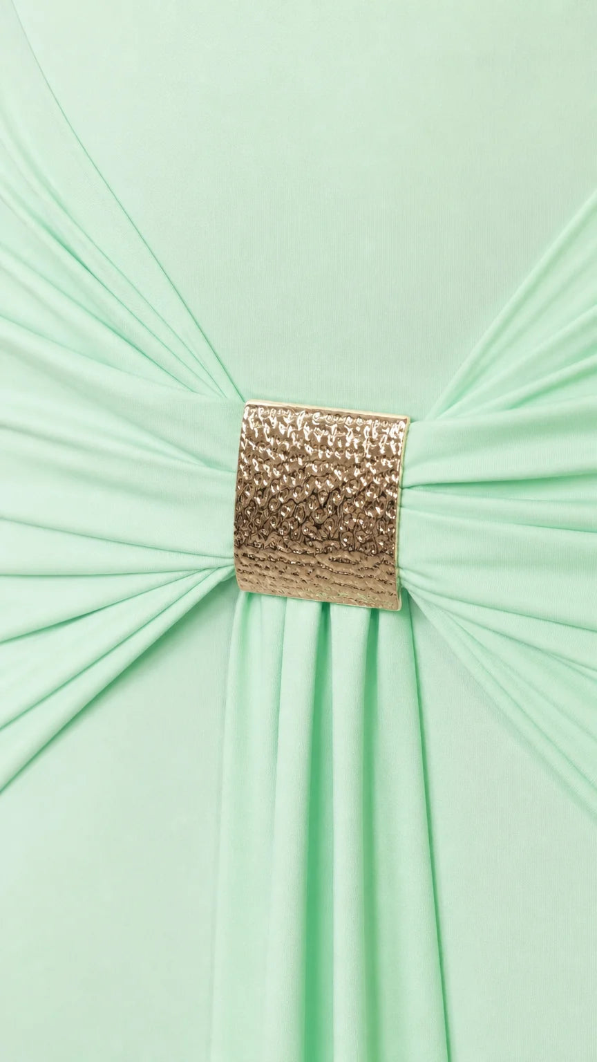 Close-up of gold metallic buckle gathering fabric on the dress