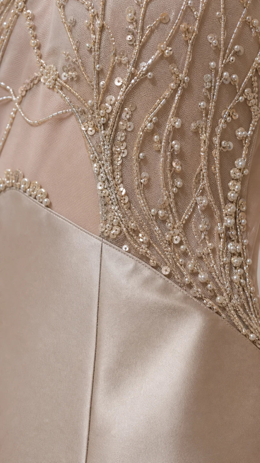 Close-up detail of intricate bead and sequin embroidery on mesh panel