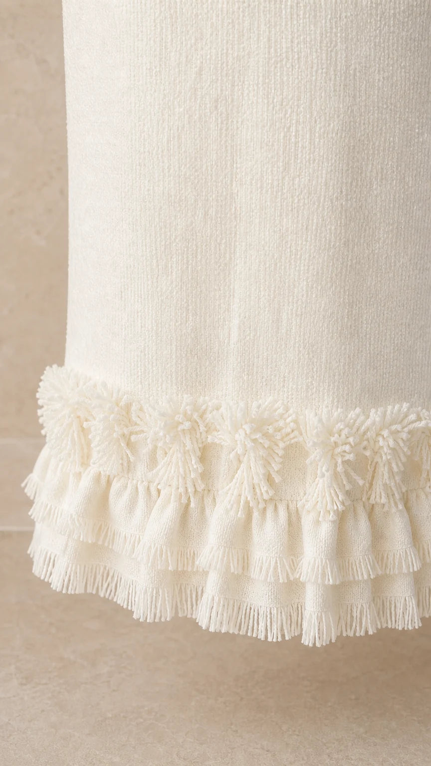 Close-up detail of the fringe hem on the white tweed maxi skirt
