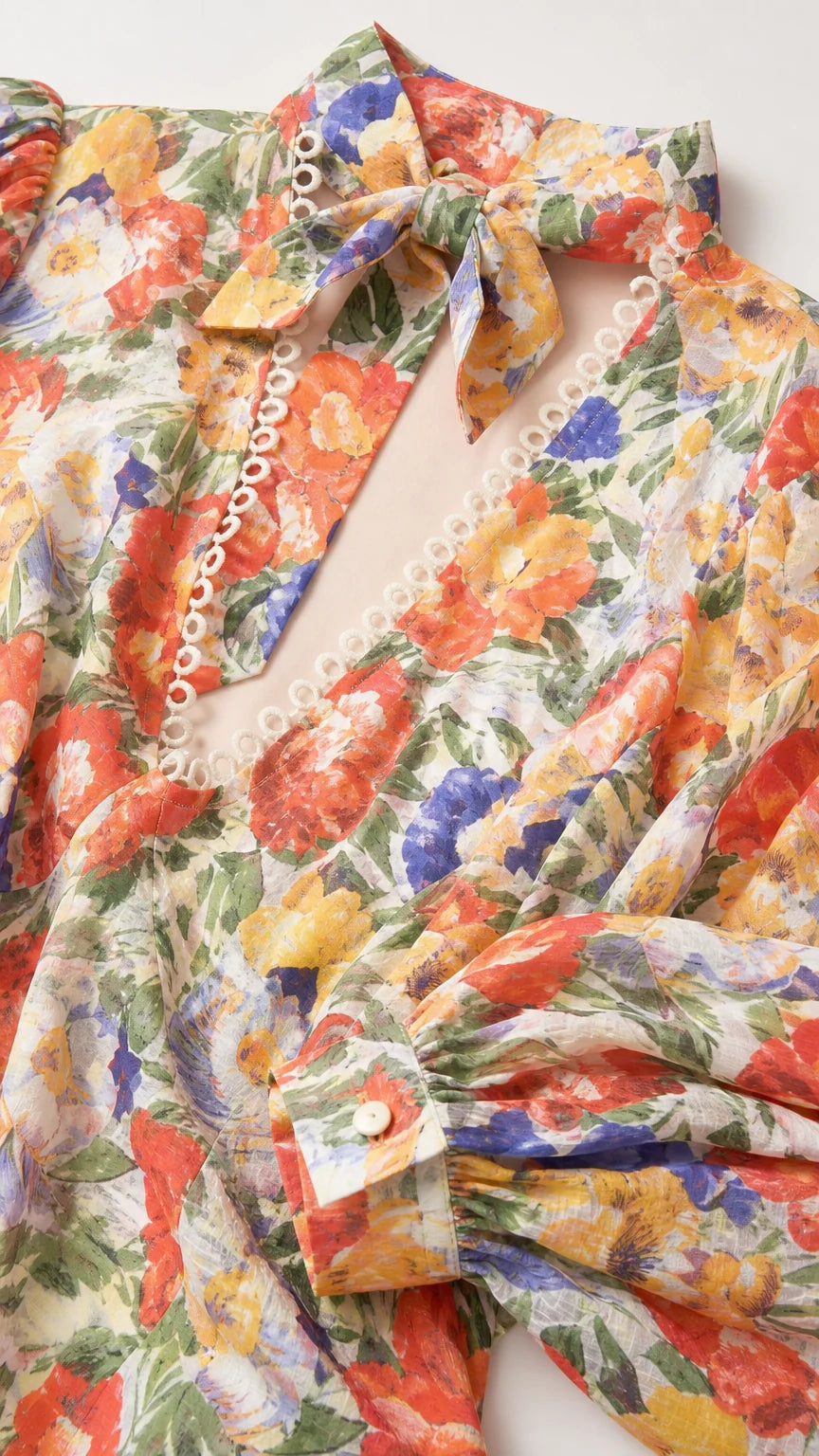 Close-up detail of fabric, buttons, and neck scarf