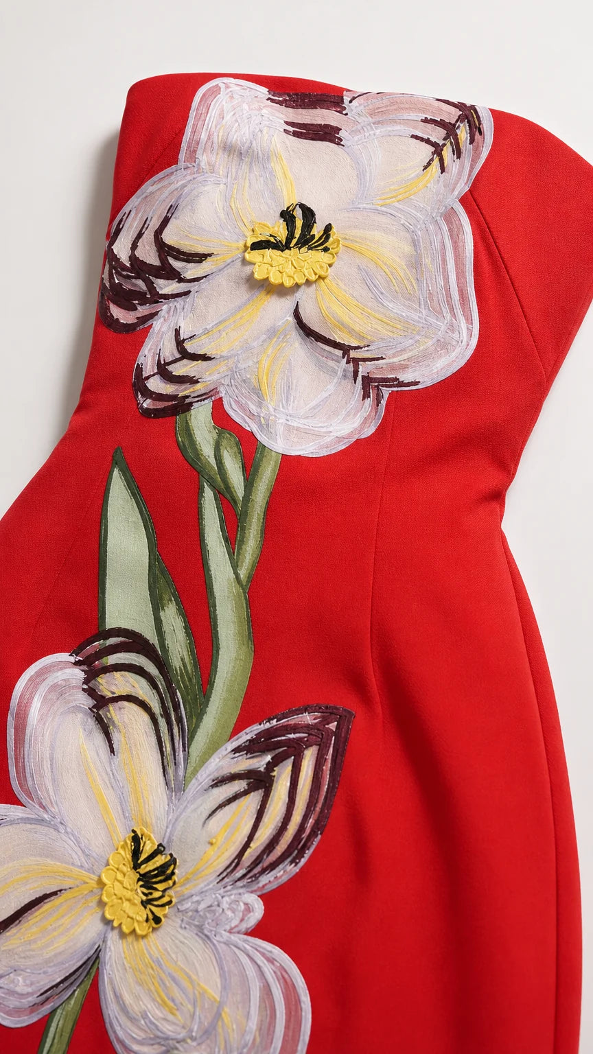 Close-up detail of floral applique on red dress