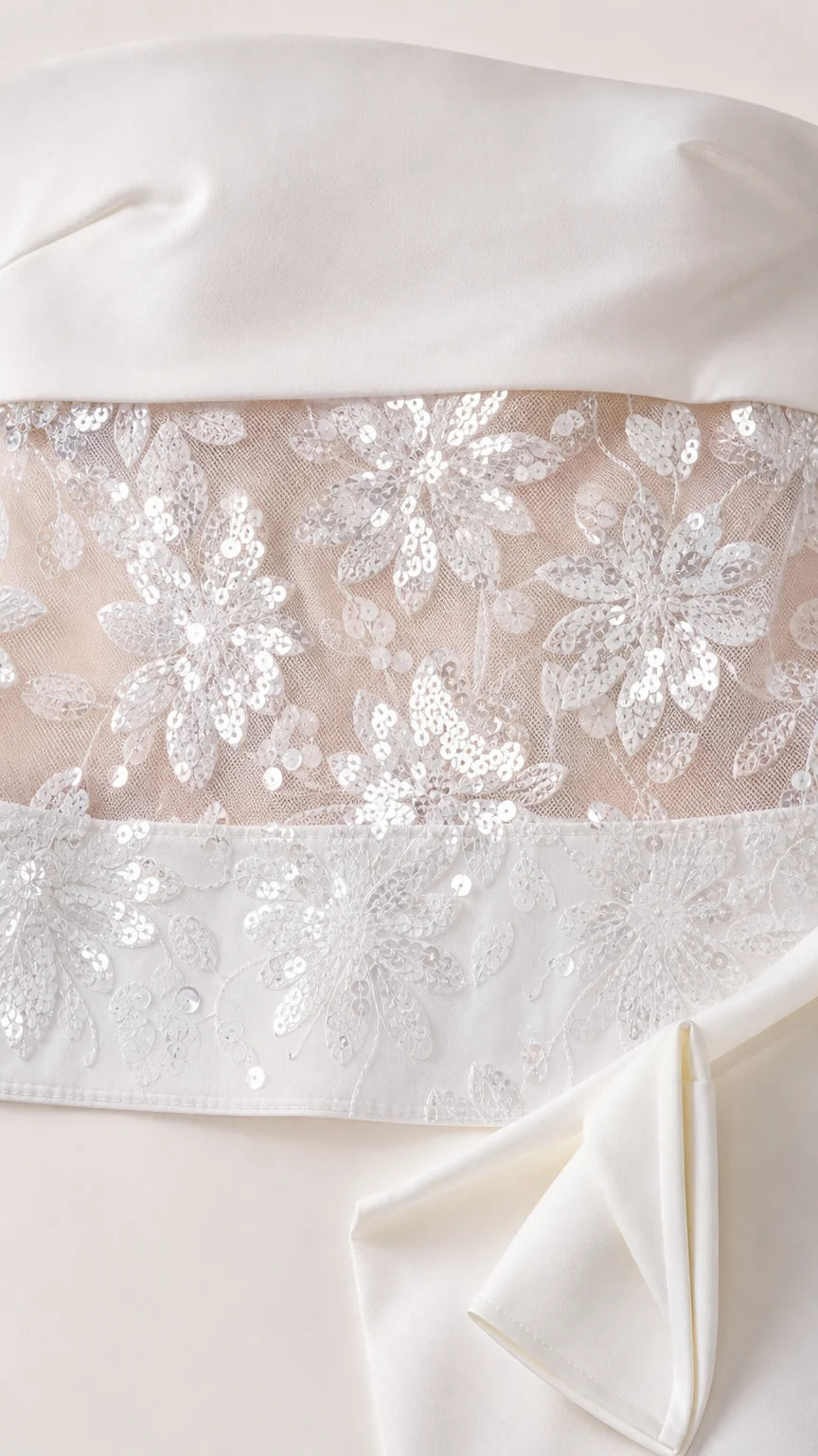 Close up detail of floral sequin embroidery on sheer mesh fabric