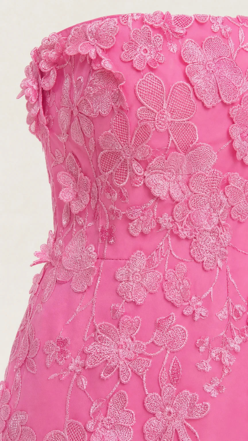 Close-up detail of textured floral appliques on pink bodice