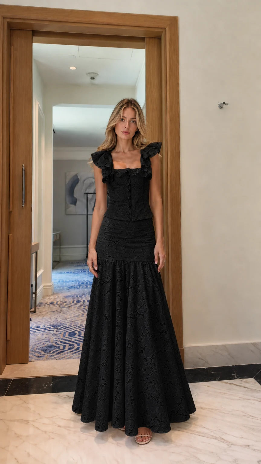 Model wearing black lace crop top and mermaid maxi skirt set